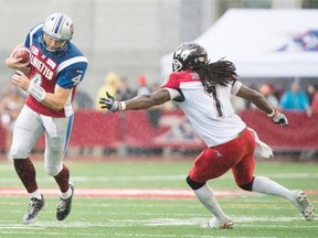 Montreal Alouettes quarterback Tanner Marsh, left, breaks away from Calgary Stampeders’ Lin-J Shell during during the second half at Molson Stadium in Montreal on Sunday, Sept. 21, 2014.