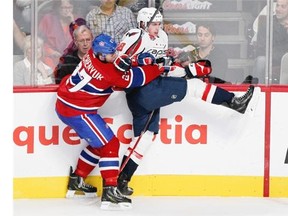 Montreal Canadiens Alex Galchenyuk checks  Washington Capitals Nate Schmidt during National Hockey League pre-season game in Montreal Sunday Sept. 28, 2014.