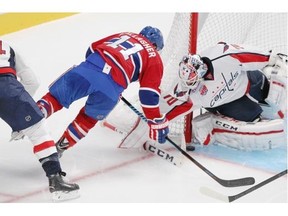 Montreal Canadiens Brendan Gallagher is knocked off his skates by Washington Capitals Brooks Orpik as he tries to score on the short side against goalie Braden Holtby during National Hockey League pre-season game in Montreal Sunday Sept. 28, 2014.
