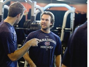 Montreal Canadiens David Desharnais, right, speaks with a teammate during the team practice at the Brossard Sports complex in Montreal on Thursday September 18, 2014.