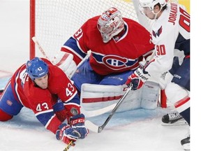 Montreal Canadiens defenceman Mike Weaver, #43, keeps his eyes on loose puck in front of goalie Carey Price and Washington Capitals Marcus Johansson during National Hockey League pre-season game in Montreal Sunday Sept. 28, 2014.