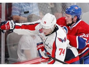 Montreal Canadiens Jiri Sekac checks Washington Capitals John Carlson as they compete for loose puck during National Hockey League pre-season game in Montreal Sunday Sept. 28, 2014.