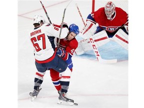 Montreal Canadiens Mike Weaver, centre, jostles with Washington Capitals Chris Brown in front of Habs goalie Carey Price during National Hockey League pre-season game in Montreal Sunday Sept. 28, 2014.