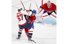 Montreal Canadiens Mike Weaver, centre, jostles with Washington Capitals Chris Brown in front of Habs goalie Carey Price during National Hockey League pre-season game in Montreal Sunday Sept. 28, 2014.