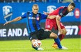Montreal Impact’s Matteo Ferrari, left, and Chicago Fire’s Quincy Amarikwa battle for the ball during second half MLS soccer action in Montreal, Saturday, August 16, 2014.
