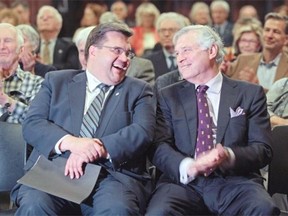 Montreal Mayor Denis Coderre, left, and Westmount Mayor Peter Trent laugh during introduction by Anne Lagacé-Dowson at an event organized by the Westmount Municipal Association at Victoria Hall in Westmount.