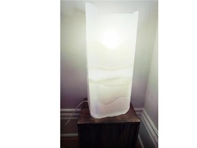 A bedside lamp made by stacking plastic laundry detergent containers in the bedroom of artist Helga Schleeh's apartment in the Notre-Dame-de-Grace district of Montreal Tuesday September 02, 2014.