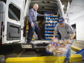 Brian Cadoret, left, and Carol Couillard loads his van with bread at Moisson Montreal.