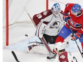 Montreal Canadiens Michael Bournival, 49, watches the puck go wide past Colorado Avalanche goalie Reto Berra and defenceman Zach Redmond during National Hockey League pre-season game in Montreal Thursday September 25, 2014.