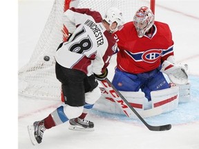 Shot goes wide between Montreal Canadiens goalie Carey Price and Colorado Avalanche's Jesse Winchester during National Hockey League pre-season game in Montreal Thursday September 25, 2014.