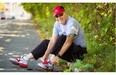 78-year-old Carl Andersen ties his shoes prior to going for a run along the de Maisonneuve bike path in the Notre-Dame-de-Grâce district in Montreal Sunday September 07, 2014. Andersen is about to pass 100,000 miles run in the last 45 years. Andersen hopes to break the milestone during this year’s Terry Fox Run.