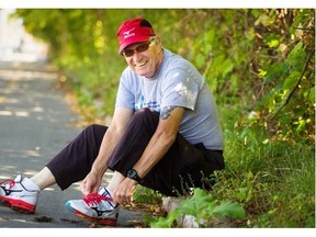 78-year-old Carl Andersen ties his shoes prior to going for a run along the de Maisonneuve bike path in the Notre-Dame-de-Grâce district in Montreal Sunday September 07, 2014. Andersen is about to pass 100,000 miles run in the last 45 years. Andersen hopes to break the milestone during this year’s Terry Fox Run.