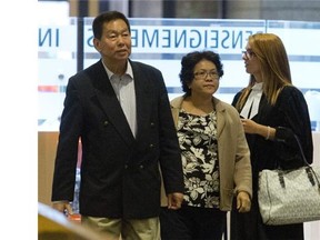 Sy Veng Chun and Leng Ky Leck, a couple accused of money laundering, along with their legal team make their way to the courtroom in Montreal, Monday, Sept, 15, 2014.