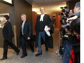 Crown prosecutor Louis Bouthillier (right) walks past media at the end of the first day of the first-degree murder trial of Luka Magnotta in Montreal on Sept. 29, 2014