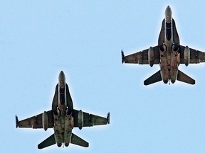 Two Royal Canadian Air Force CF-18 fighter jets perform a fly-over at start of Montreal Alouettes versus Hamilton Tiger Cats Canadian Football League game in Montreal Sunday Sept. 7, 2014.