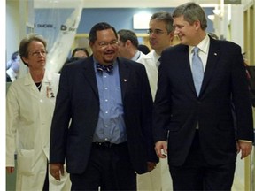 Arthur Porter talks with Prime Minister Stephen Harper during a visit to Montreal in 2008. In his book, Porter describes Harper as a man of few words who looks like an accountant or economist.