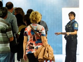 Potential jurors are instructed by a special constable while they line up at the Montreal Courthouse as jury selection begins in the Luka Magnotta murder trial in Montreal, Monday, September 8, 2014.