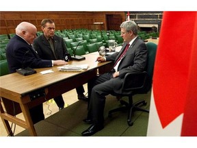 Prime Minister Stephen Harper chats with senators Mike Duffy, left, and Percy Mockler following a caucus meeting on Parliament Hill, on Oct. 17, 2012.