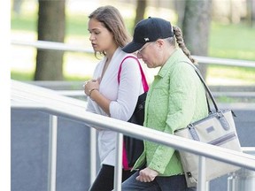 Pamela Porter, right, wife of accused fraudster Arthur Porter, arrives at SQ headquarters in Montreal on Wednesday.