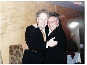 On Thursday, Sept. 4, 2014,  this picture was entered into evidence at the Charbonneau Commission, showing former premier Jean Charest grinning broadly as he embraces construction magnate Tony Accurso. Along one side of the image, a handwritten message from Charest reads: “Dear Tony, thanks for your support. In friendship, Charest 2001.