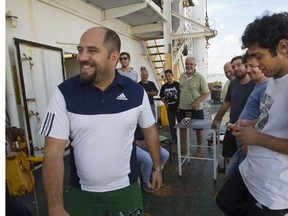 Phoenix Sun captain Semih Ozkan, left, and his crew enjoyed a rare ray of sunshine Friday as members of the Sorel community offered money and support. The sailors came from Turkey to Sorel in April, hoping to make minor repairs to the ship before sailing it across the Atlantic.