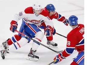 Nikita Scherbak, left, gets tangled up with Francis Bouillon with Joe Finley looking on during the Montreal Canadiens Red-White intra-squad game at the Bell Centre in Montreal Monday, Sept. 22, 2014.