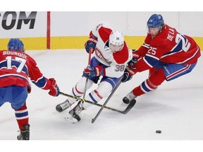 Nikita Scherbak tries to get between Rene Bourque and Jacob de la Rose during Montreal Canadiens Red-White intra-squad game at the Bell Centre in Montreal Monday, Sept. 22, 2014.