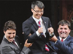 The Liberals are riding high a year before the next federal election. Leader Justin Trudeau, left, and MP Dominic LeBlanc, right, escort new Liberal MP Arnold Chan into the House of Commons on Monday.