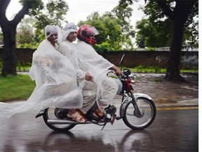 Pakistani men, covered in plastic sheets as improvised ponchos, ride on a motorcycle during heavy rain in Islamabad on September 4, 2014. More than 35 people have been killed as a result of heavy monsoon rains in Pakistan, officials said on September 4, as authorities warned more intense rainfall and flash floods could be imminent. Most of the deaths were caused by roof collapses in buildings in Punjab, Pakistan's richest and most populous province, with 13 people killed in the provincial capital Lahore.