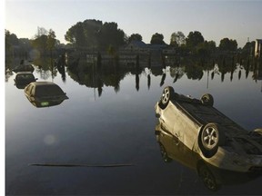 Partially-submerged vehicles are seen in a flooded neighbourhood at the Raj Bagh locality in central Srinagar on September 26, 2014. The floods, which hit on September 7, killed over 450 people across India and Pakistan and caused devastating economic losses running into billions of dollars, with separatists heavily criticising New Delhi's response in India-administered Kashmir.
