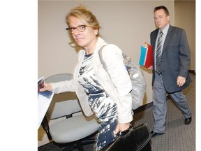 Patrice Crevier, lawyer for the city of Montreal, rear, enters a Quebec Labour Board hearing following a failed mediation attempt into the city of Montreal’s complaint about a June 17 protest at City Hall. The city claims members of unions representing police, firefighters, office workers and blue collar workers illegally deprived the public of service for at least 15 minutes on that day to participate in a protest against planned pension reforms. The Labour Board hearing was held in Montreal on Tuesday September 2, 2014.