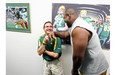 Patrick Kabongo give a gentle forearm to Dwayne Mandrusiak as he shows players the equipment room after the official opening of the Edmonton Eskimos brand new dressing room in Commonwealth Stadium in Edmonton Alberta on Saturday July 3, 2010.
