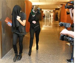 People who were inside the courtroom where Luka Magnotta’s first-degree murder trial was being held Monday, September 29, 2014 walk past media at the end to the day’s session. Magnotta is accused of killing  Lin Jun. Magnotta’s first-degree murder trial got underway at the Montreal courthouse.