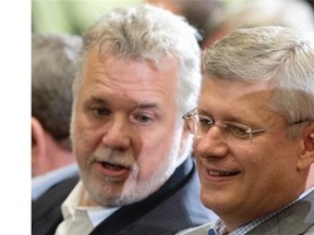 Prime Minister Stephen Harper, right, chats with Quebec Premier Philippe Couillard at a celebration marking the 200th anniversary of the birth of George-Étienne Cartier, Saturday, September 6, 2014 in Quebec City.