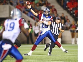 Quarterback Jonathan Crompton #18 of the Montreal Alouettes throws a pass to teammate S.J. Green #19 against the Ottawa Redblacks during a CFL game at TD Place Stadium on September 26, 2014 in Ottawa, Ontario, Canada.