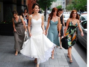 ZoÎ Quinn-Phillips on her wedding day seven years ago. Today, her dress is packed away, but she's worn it in a fashion show that the designer, Janine Adamyk, was featured in. "It makes me feel like a goddess." For Saturday Extra feature to be published on Sept. 6, 2014, about the fate of wedding dresses after the wedding.  Photo courtesy of ZoÎ Quinn-Phillips & Bo Huang Photography