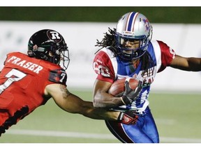 Redblacks’ Eric Fraser attempts to stop Alouettes’ James Rodgers during Als’ win in Ottawa Friday night. Fred Chartrand/ THE CANADIAN PRESS