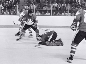 Rogatien Vachon covers the puck while Carol Vadnais of team Canada looks on against team Czechoslovakia during a Canada Cup game on Sept. 13, 1976 in Toronto.