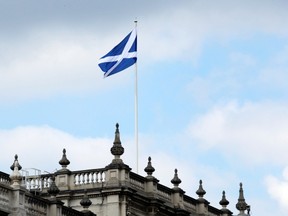 The Saltire flies on a government building at Whitehall in central London, Wednesday, Sept. 10, 2014. British Prime Minister David Cameron abandoned party politics for pure emotion Wednesday, imploring Scots not to break his heart by voting to become independent from the United Kingdom. Conservative Party chief Cameron, Labour leader Ed Miliband and Liberal Democrat chief Nick Clegg all pulled out of a weekly House of Commons question session in London to make a late campaign dash to Scotland as polls suggest the two sides are neck-and-neck ahead of next week’s independence referendum that could break Scotland’s 307-year union with the kingdom.