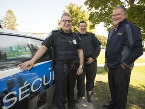 François Plaisance, right, president of the security firm VCS Consulting Group, with security officers Jimmy Dessureault, left, and Miguel Laporte, who have been patrolling the town of St-Lazare.