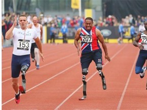 Silver medalist Derek Derenalagi (C) of Britain competes with gold medalist Philippe Robert (L) of France and bronze medalist William Reynolds of the United States in the 100m Men Ambulant IT2 final during Day 1 of the Invictus Games on Sept. 11, 2014, in London, England.