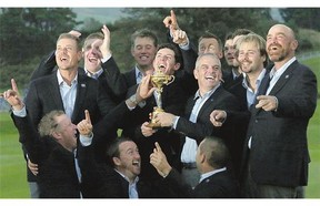 Europe team captain Paul McGinley, holding the trophy, and his team celebrate after winning the Ryder Cup on Sunday.