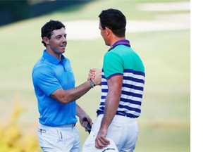 Rory McIlroy of Northern Ireland, left, and Billy Horschel of the United States shake hands on the 18th green during the third round of the Tour Championship at the East Lake Golf Club on Saturday in Atlanta.