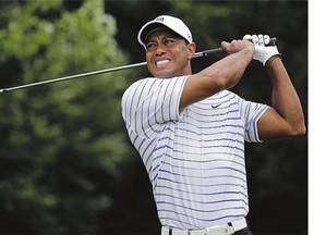 Tiger Woods winces after a tee shot at the PGA Championship in Louisville, Ky., on Aug. 8. Woods is hoping to return to competitive golf in December.