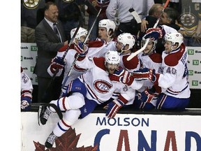 Montreal Canadiens left wing Max Pacioretty (67) leaps from the bench as teammates celebrate a 3-1 win over the Boston Bruins in Game 7 of a second-round NHL hockey Stanley Cup playoff series, in Boston on Wednesday, May 14, 2014. The Canadiens advanced to the Eastern Conference finals against the New York Rangers.