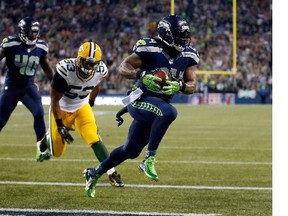 Running back Marshawn Lynch (#24) of the Seattle Seahawks scores a touchdown as linebacker Nick Perry (#53) of the Green Bay Packers gives chase during the third quarter of the game at CenturyLink Field on September 4, 2014 in Seattle, Washington.
