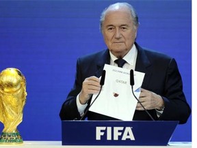 FIFA president Sepp Blatter holds up the name of Qatar during the official announcement of the 2022 World Cup host country at the FIFA headquarters in Zurich in 2010. Blatter has said it was a mistake to choose Qatar because of the country's searing summertime climate.