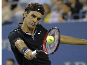 Roger Federer of Switzerland returns a shot to  Gael Monfils of France during their 2014 US Open Men's Singles Quarterfinals match at the USTA Billie Jean King National Tennis Center September 04, 2014 in New York.