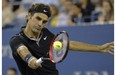 Roger Federer of Switzerland returns a shot to  Gael Monfils of France during their 2014 US Open Men's Singles Quarterfinals match at the USTA Billie Jean King National Tennis Center September 04, 2014 in New York.