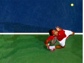 Switzerland's Roger Federer serves a ball during his Davis Cup semifinal tennis match against Italy's Simone Bolelli   in Geneva  Friday Sept. 12, 2014.